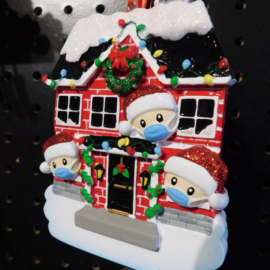 Family with masks on ornament