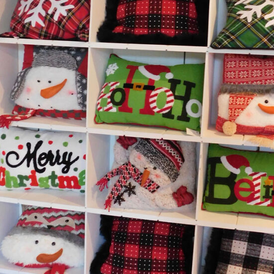Assortment of Christmas pillows on a shelf