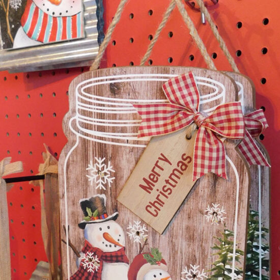 Assorted Christmas signs hanging on a wall